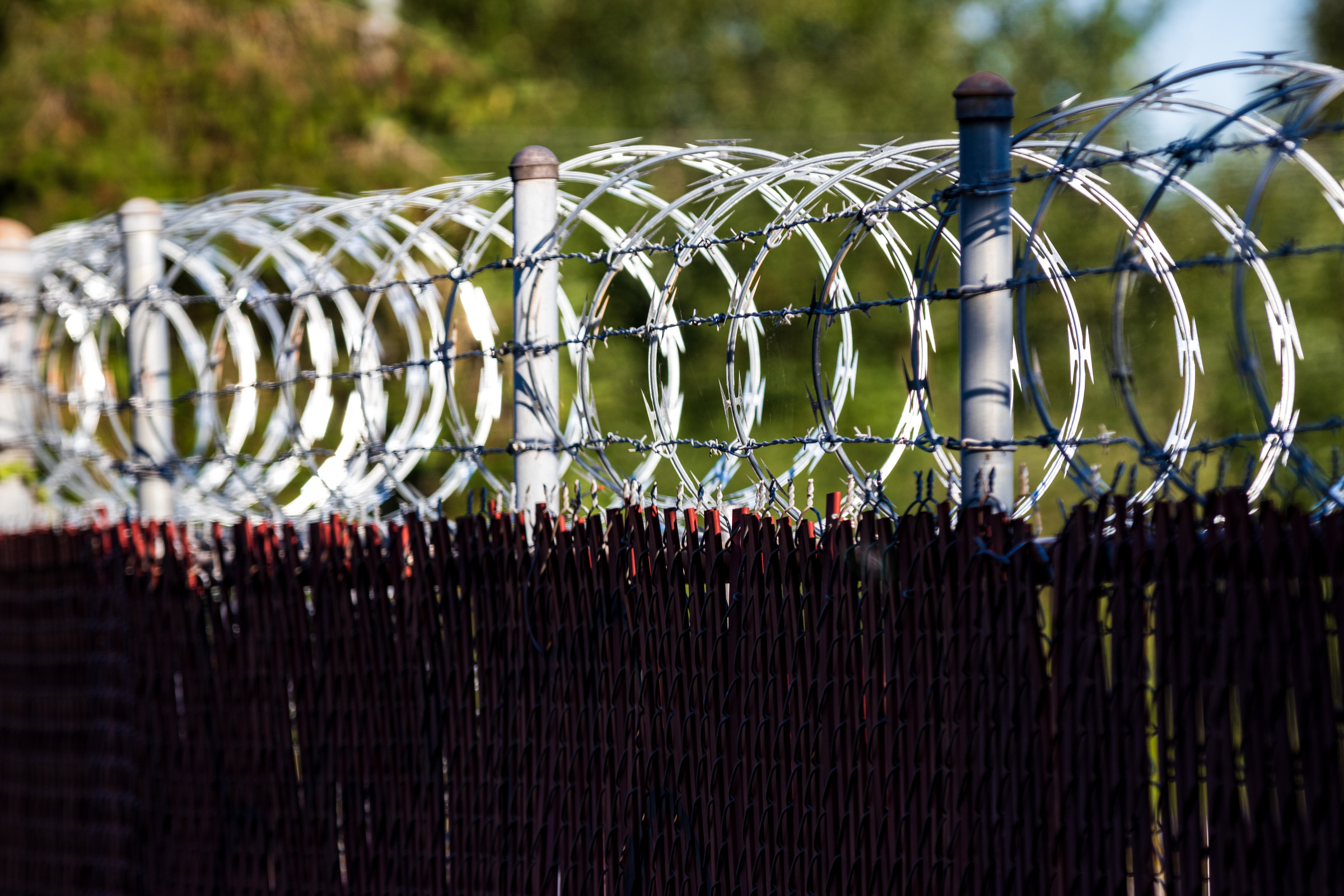 Razor wire fence shining in the sun